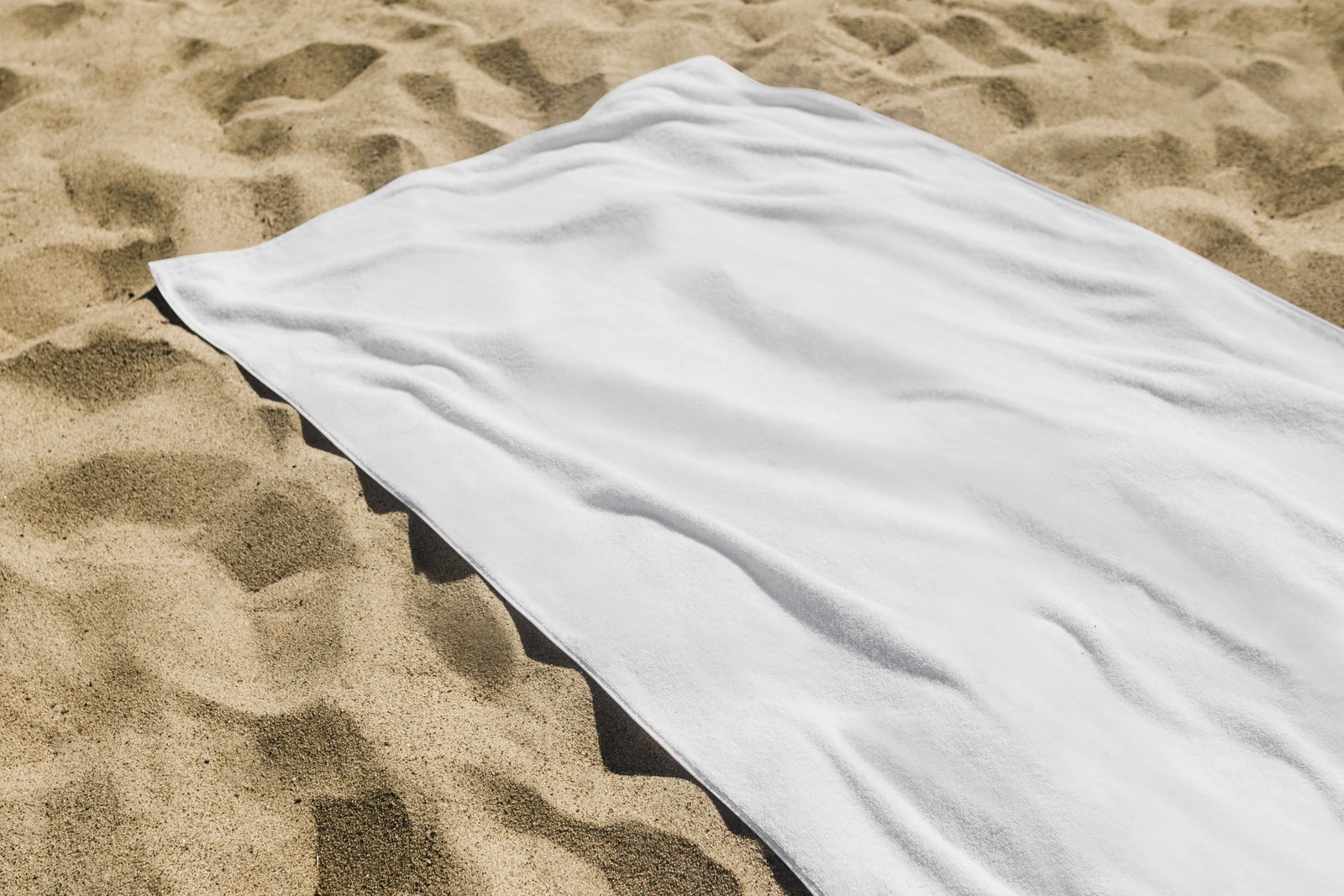 White beach towel on the sand